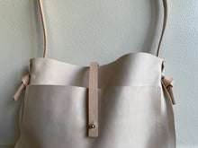 Load image into Gallery viewer, Edie Kahula Pereira Goods Veg Tan Leather crossbody bag with large exterior front pocket&amp;closure strap named Nomadic designed and made by Edie Kahula Pereira  www.ediekahulapereira.com
